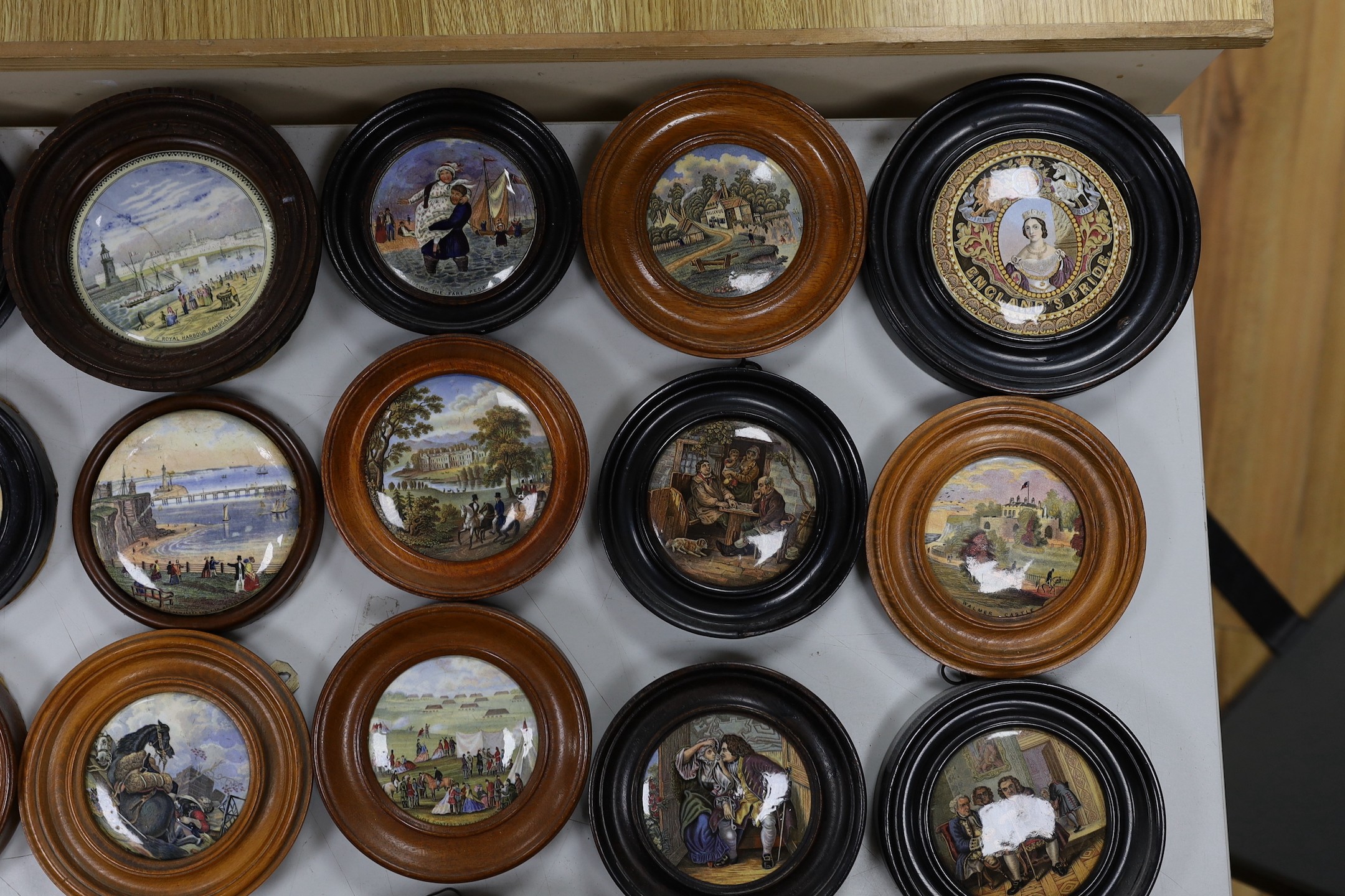 A collection of 19th century Prattware pot lids (23)